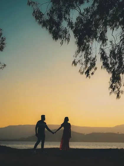 There is a special magic in the moments just before sunset. For this pre-wedding shoot by the water, I used the golden hour light to create a romantic silhouette, capturing the couple's quiet intimacy against a breathtaking sky. These are the cinematic, emotional frames I love to create.