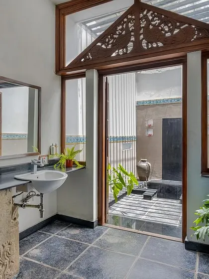 The bathroom in the Vasishta suite, with a view into the private open-air bathing area.