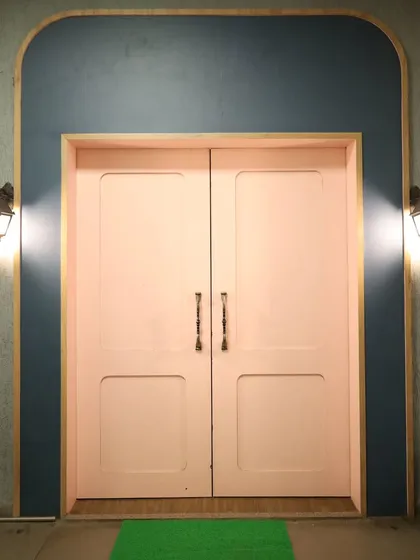 The charming entrance to our creative space. The pink doors and warm lighting offer a welcoming vibe for all artists.