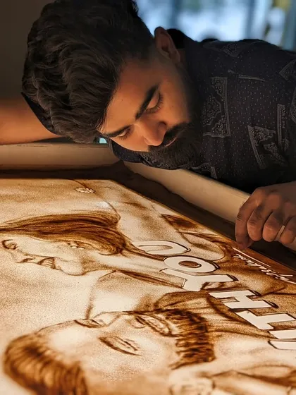 Another angle of me working on the 'With You' sand art, smoothing the sand to create the perfect texture.