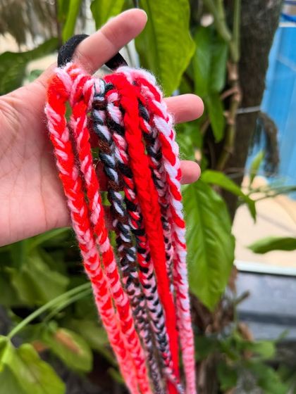 A close-up of our crochet hair braids in a red, white, and black color combination.
