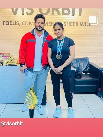 Standing with my coach at Vis Orbit after a successful Uttarakhand powerlifting championship. The medals and trophy represent countless hours of hard work.