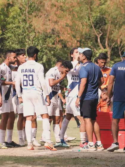 The team huddles around the manager and coach for instructions. Unity and a clear game plan are fundamental to how we operate as a professional football club.