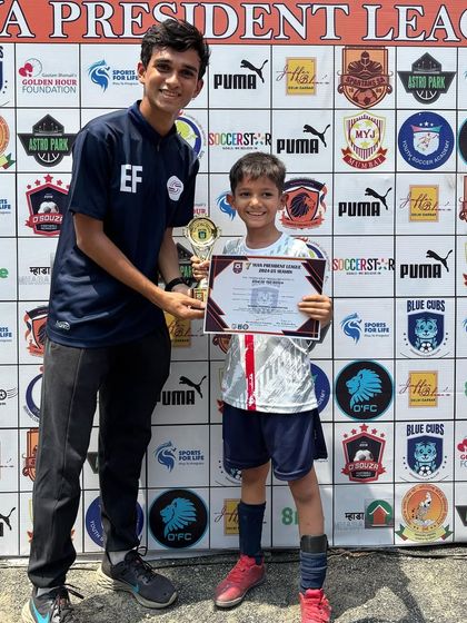 Coach Ethan presenting the 'Player of the Match' award to Shivatva, highlighting the supportive relationship between our coaches and players.