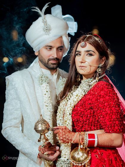 A powerful portrait of the bride and groom at Noor Mahal Palace, with the bride holding a traditional incense burner, adding a touch of mystique and tradition.