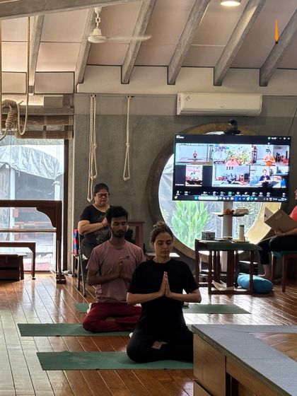 A hybrid class in session, with students both in the studio and on the screen. The energy of the group is shared, no matter the distance.