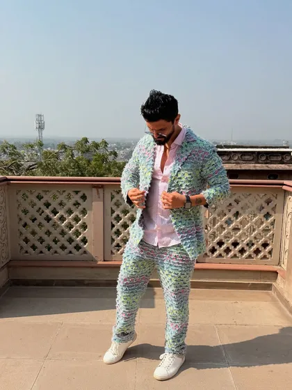Adjusting the jacket of my textured suit. A cool, confident pose that shows off the outfit's details.