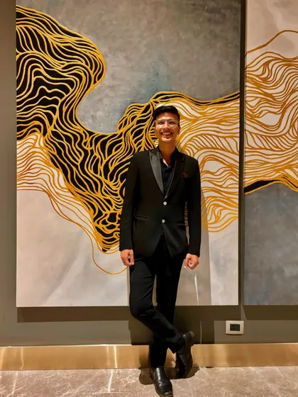A moment of joy before a Diwali-themed corporate show. The art on the wall perfectly matched the vibrant energy of the evening.