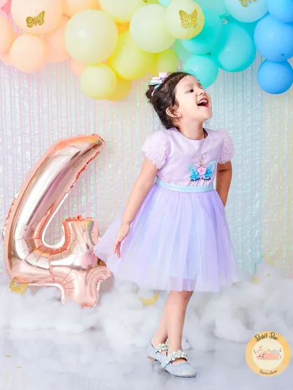 We celebrate birthdays beyond the first year too! This joyful shot from a fourth birthday unicorn-themed session shows how we create magical experiences for growing kids, filled with laughter and fun.