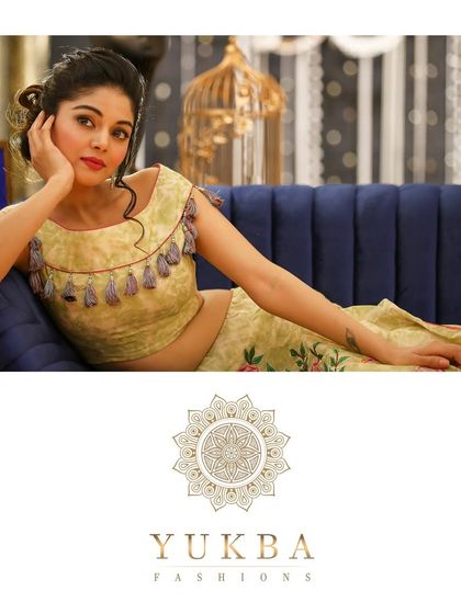 A relaxed shot of a model wearing the floral embroidered lehenga and crop top, showcasing its modern and comfortable feel.