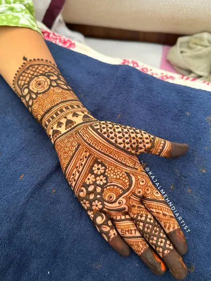 A close-up of a bridal design showing the groom's name, Smit, cleverly hidden within the intricate patterns.