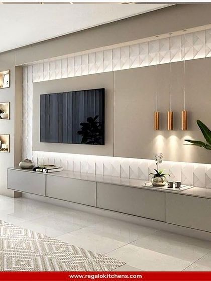 A contemporary TV unit with a textured white back panel and floating grey console. The asymmetrical shelving and pendant lights add a unique, designer touch.
