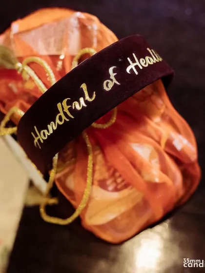 A 'Handful of Health' wedding favor. We work with our clients to create thoughtful and unique giveaways that reflect their personality and care for their guests.