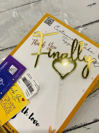The "Finally" topper shown in its packaging, complete with a thank you note and instructions.