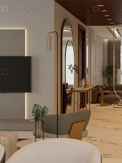 A perspective showing the layered design of the living space, with a sleek, back-lit TV wall and elegant, arched floor mirrors that add depth and reflect light.