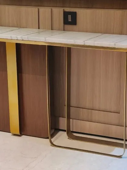 Another custom console table, this one combining a wooden cabinet with a sleek metal frame and a marble top.