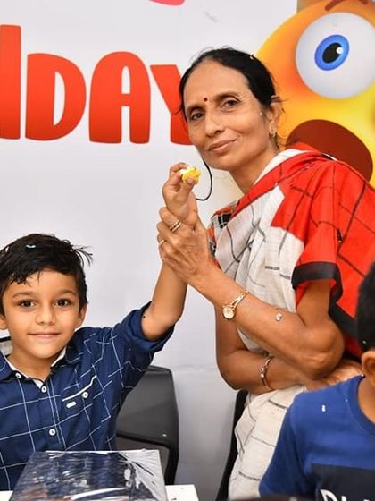 A grandmother shares a special moment with her grandson during his birthday party. Our venue is perfect for creating these warm, multi-generational family memories.