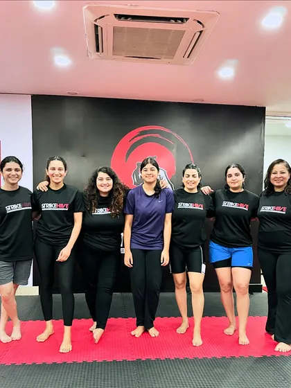 The women of StrikeHive posing together after a challenging training session. We celebrate the camaraderie and mutual support that defines our community.