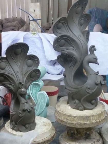 This is the 'before' stage of our clay art projects. Here are two peacock sculptures shaped from clay, ready to be painted and finished.