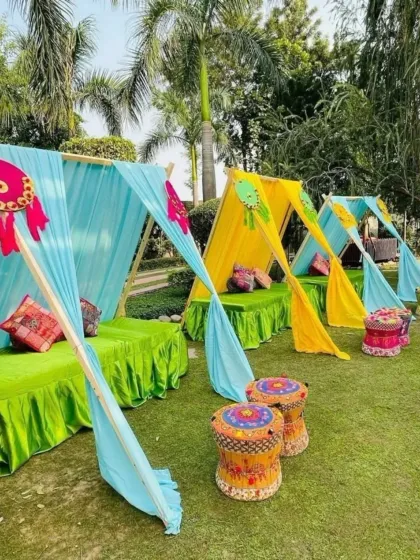 A creative and casual seating arrangement for a Mehendi function, using tent-like drapes and colorful floor cushions. This is perfect for a relaxed, bohemian-themed event.