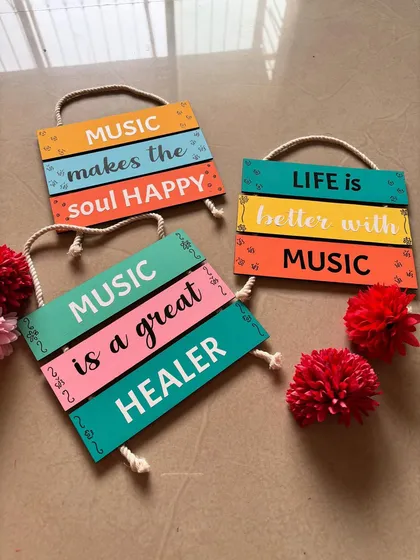 Another angle of the music-themed wall hangings, showing their vibrant colors and rustic rope detail.