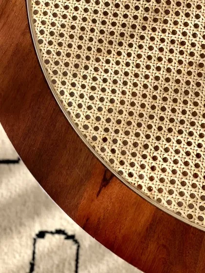 A close-up showing the edge of the coffee table, highlighting the quality of the wood finish and the clean joinery.
