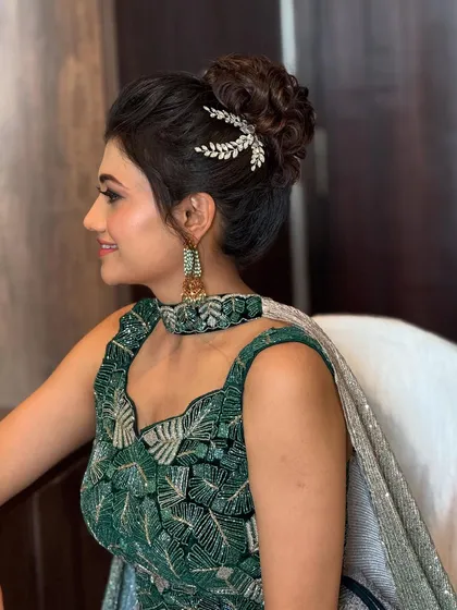 A classic, elegant updo is perfect for a reception or cocktail party. I crafted this textured messy bun to look effortlessly chic, finishing it with a delicate, leaf-inspired crystal accessory to catch the light beautifully.