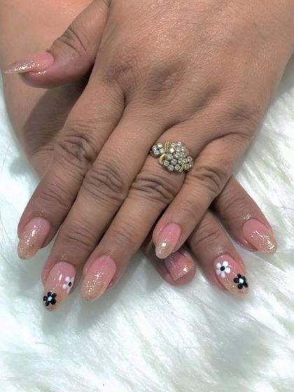 A sweet and simple design with a shimmery nude base and small, hand-painted black and white flowers.