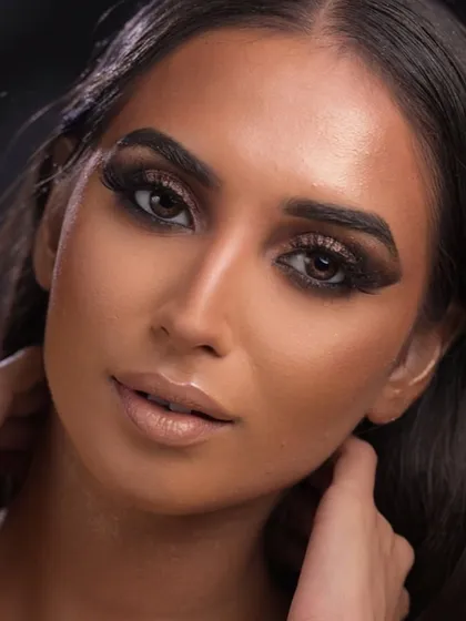 A full glam look with a dramatic, dark smokey eye and a perfectly contoured face, ready for any red carpet or high-fashion event.