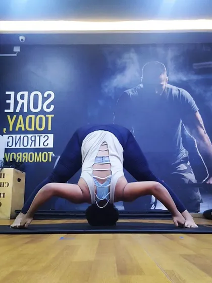 Another perspective of the wide-legged forward bend, showing the alignment of the head, spine, and legs. Correct alignment is key to getting the full benefit of any stretch.