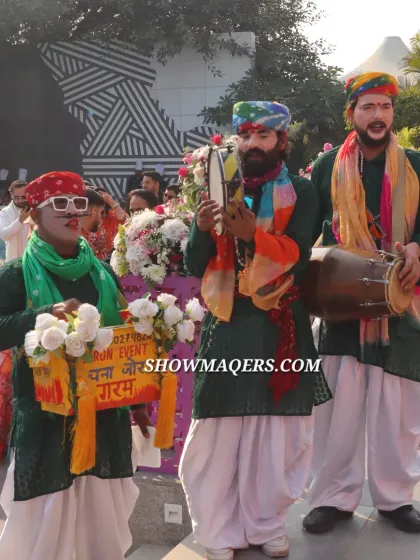 Folk performers entertain guests, adding a traditional and interactive element to the modern Haldi celebration.