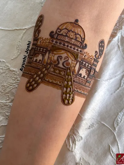 A beautiful and symmetrical armband design with peacocks and swans, perfect for a bridal or engagement mehendi.