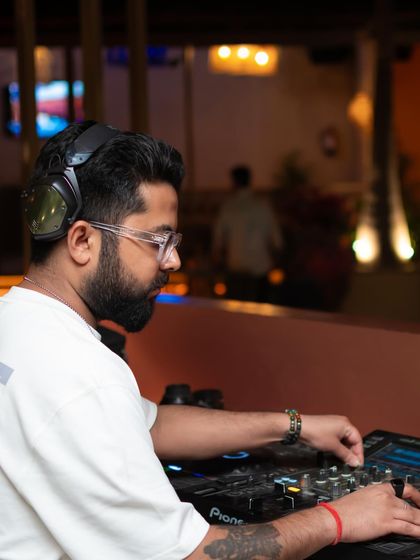 A side profile shot of me at the decks, concentrating on the next transition to keep the energy flowing.