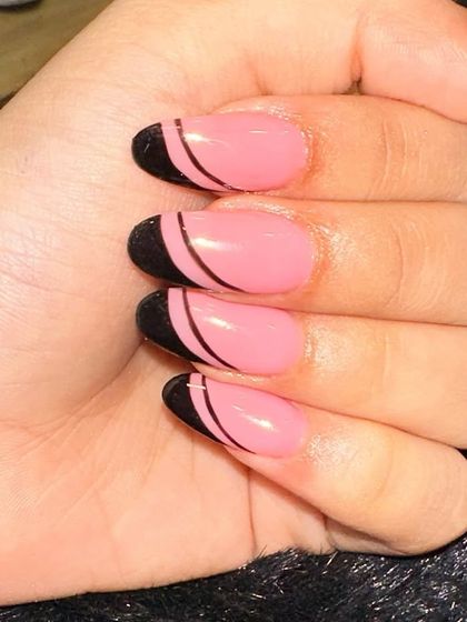 A clean and graphic look with a pop of color. I used a bright pink base and added a bold black French tip with a thin, curved line separating the two colors for a modern, minimalist feel.