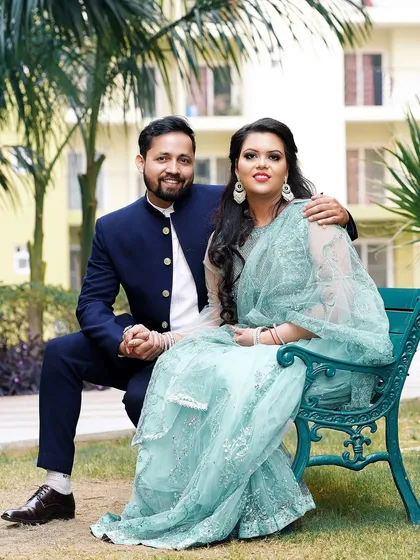 A relaxed and happy portrait of the couple on a park bench. This shows the comfortable and easy love they share.