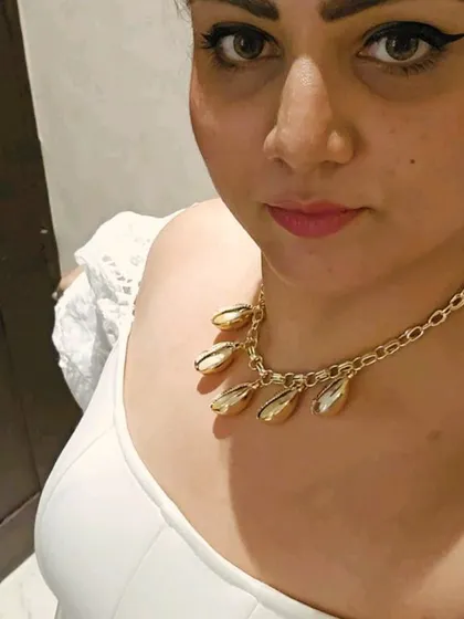 Another look at the statement shell necklace. It's the perfect accessory to make a simple white top feel like a party-ready outfit.