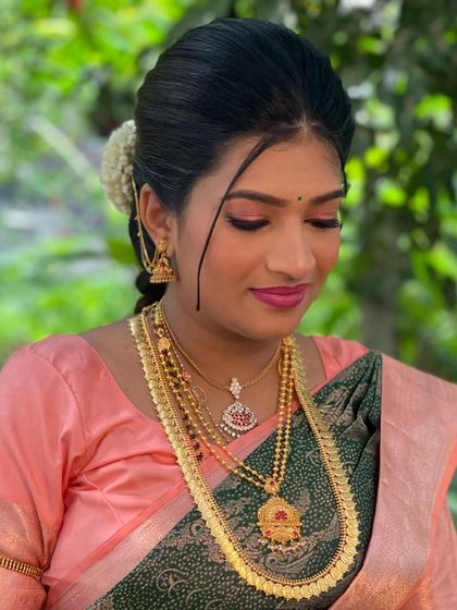 A close-up of Roja's makeup, featuring shimmery pink eyeshadow and a matching lip color.