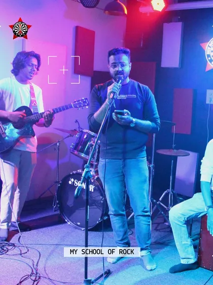 A trio jamming on stage during Open Mic Challenge 64. It's amazing to see musicians who've just met create something incredible together.