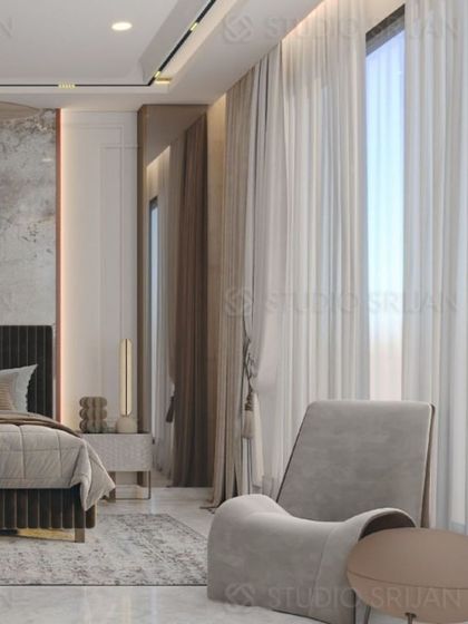 This angle shows the use of a large, comfortable armchair to create a reading nook by the window.