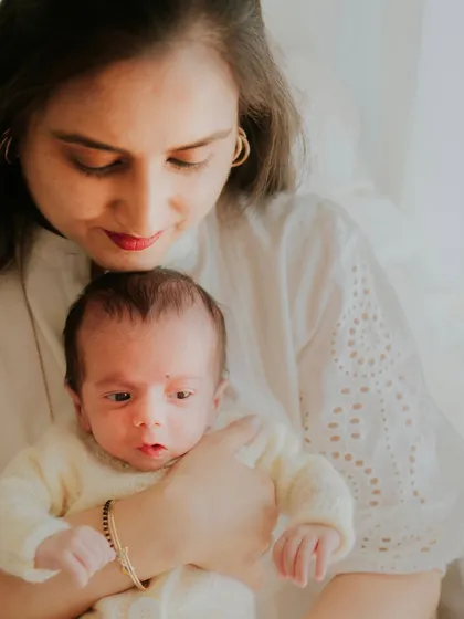 A new mother looking at her baby with awe and love. These first few days are so precious and worth capturing.