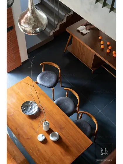An overhead shot of the dining table highlights the beauty of the custom woodwork and the simple, elegant styling.
