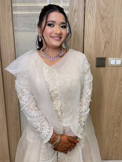 A happy client ready for her sangeet night, with a hairstyle that's both glamorous and comfortable.