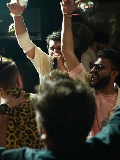 The energy at our events is everything. This shot captures the pure joy and excitement of a live performance during one of our DJ nights, where students and pros share the stage.