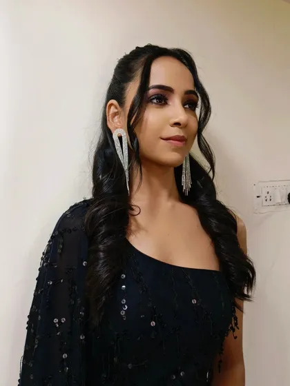 Another shot of this elegant party makeup. The soft curls and face-framing tendrils add a touch of romance to the overall look.