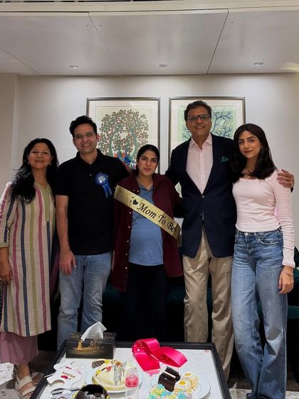 With my family and colleagues celebrating an upcoming arrival. I am a strong advocate for supporting women in the legal profession through all stages of life, including pregnancy.