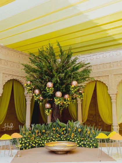 Reality: The Haldi ceremony in full swing. The yellow drapes and sunflower arrangements transform the Suryagarh courtyard into a vibrant, joyous space, just as our render promised.
