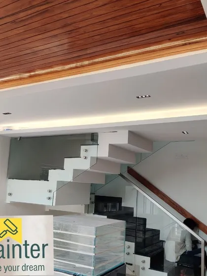 For this modern staircase, we applied a natural polish to the wooden ceiling panels. This complements the minimalist design while adding warmth and texture to the space.
