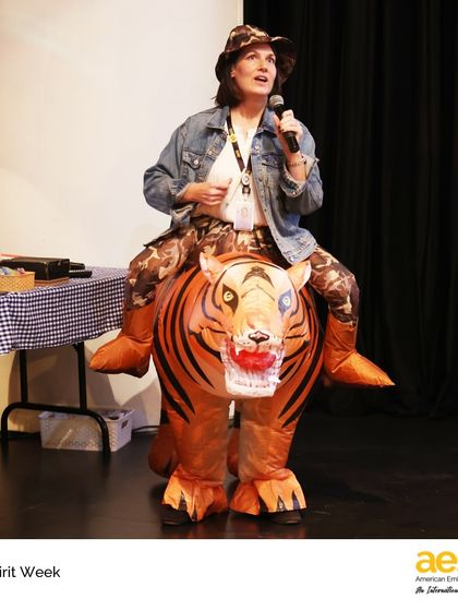 A teacher goes all out with an inflatable tiger costume for 'animal day'. This level of enthusiasm is what makes Spirit Week at AES an unforgettable experience for everyone involved.
