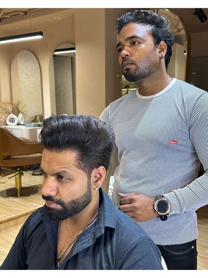 A close-up of a client's transformation. The high-volume hairstyle and perfectly groomed beard make a strong style statement.