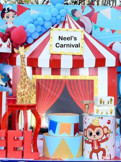 More details from the carnival setup, including a monkey prop and a sign for "Neel's Carnival."